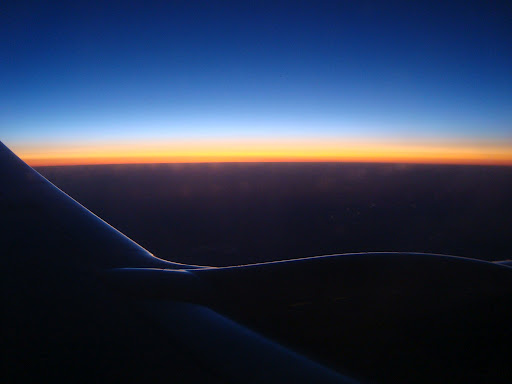 sunset over the wing of an airplane