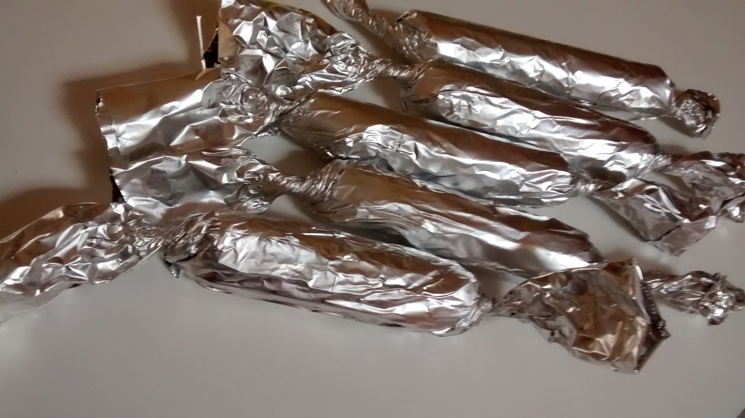 vegan Chiang Mai sausages wrapped in foil 