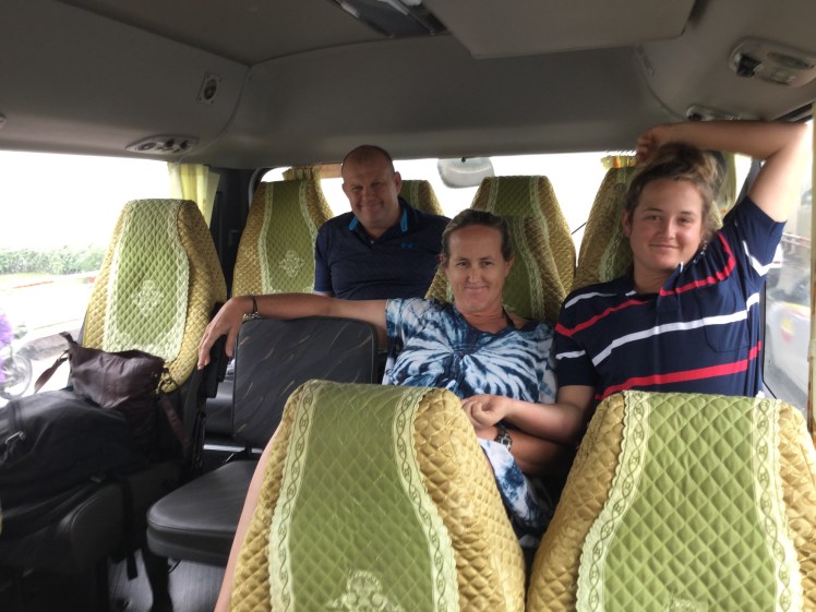 friendly travelers on the bus from Hanoi to Halong Bay, Vietnam.