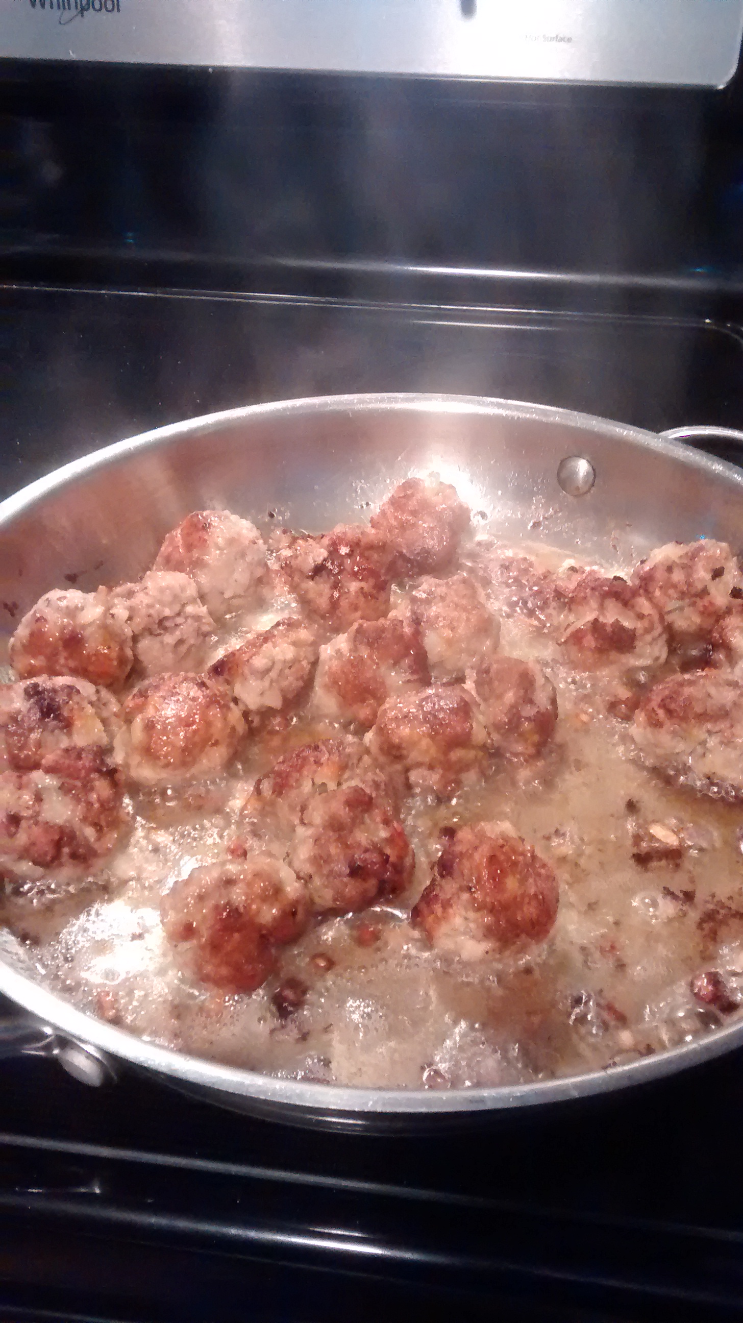 close up of traditional Swedish meatballs cooking.