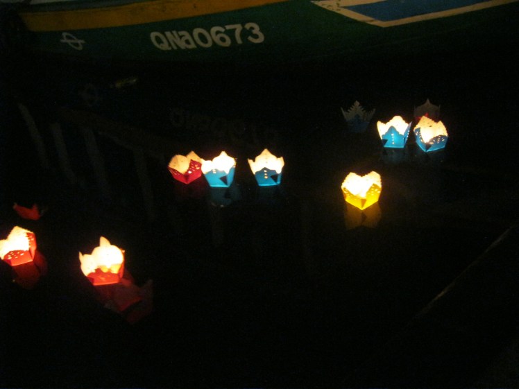 Lanterns holding candles are purchased by tourists and sent out into the canals. Photo by Charish Badzinski.