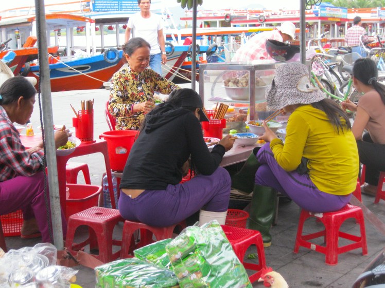 Locals enjoy their breakfast at the Central Market in Hoi An. Photo by Charish Badzinski.