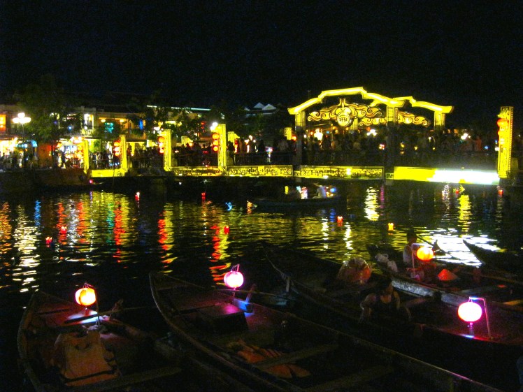 The Japanese bridge glows at night, as passenger boats wait for tourists. Photo by Charish Badzinski.